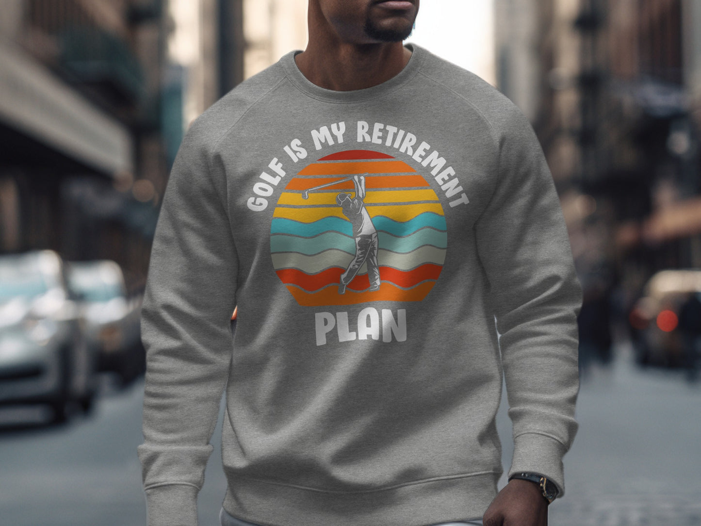 Grey sweatshirt with graphic: golfer swinging at sunset, "Golf Is My Retirement Plan"