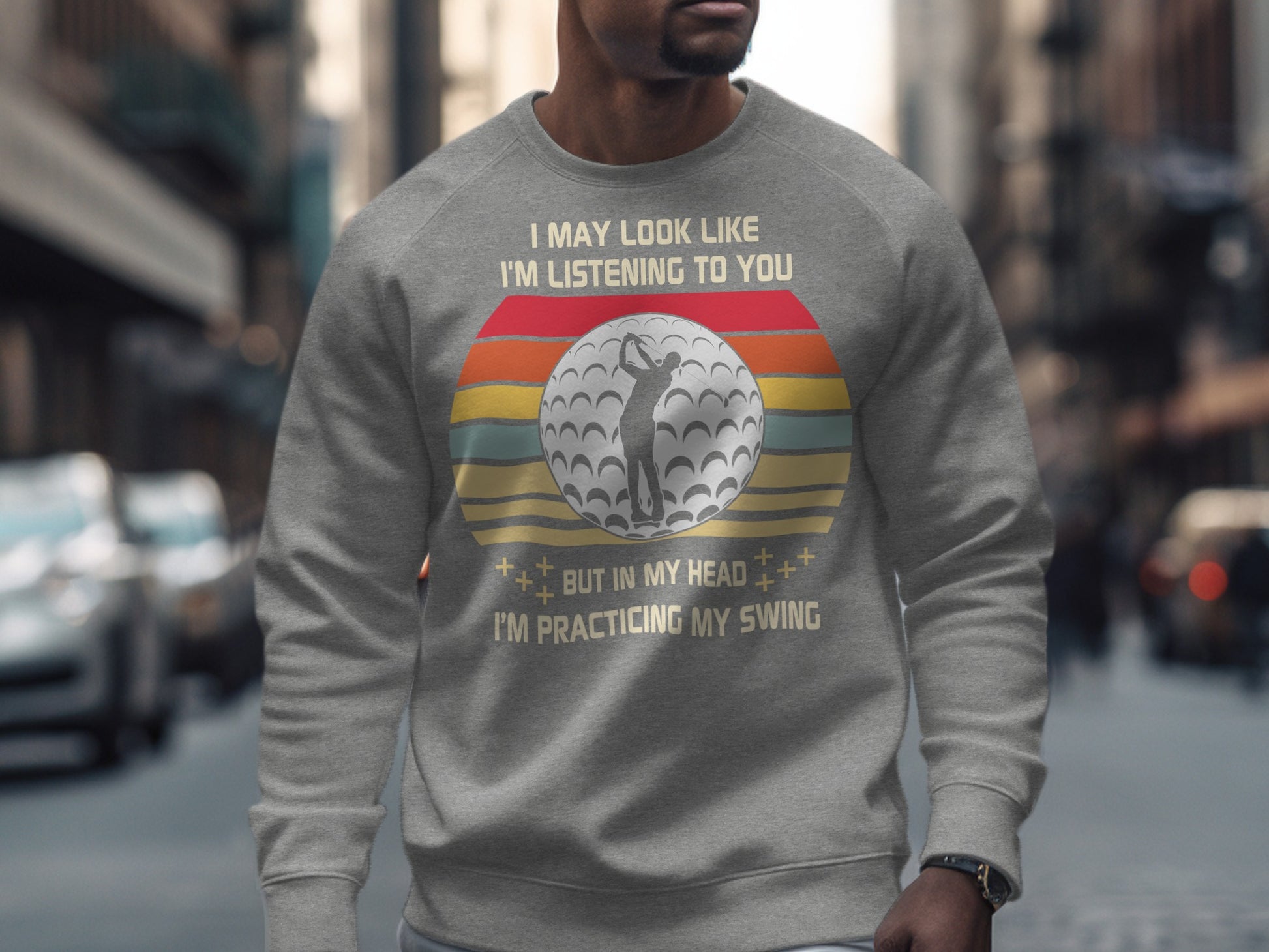 Gray sweatshirt with "Practicing My Swing" text and golf ball graphic.