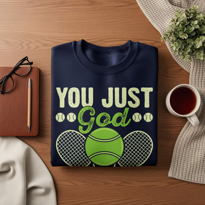 Navy sweatshirt with "YOU JUST God" text, tennis balls, and rackets.