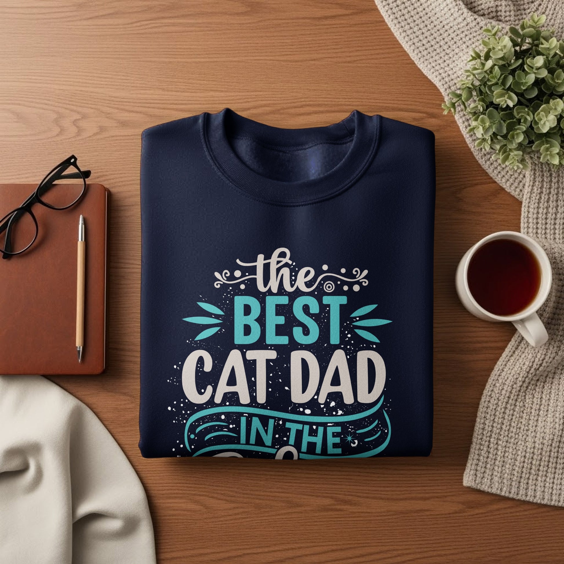 Navy sweatshirt with "the best cat dad in the" text and cat paw graphics.