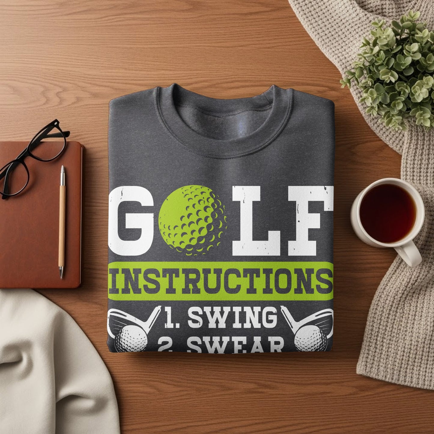 Dark gray sweatshirt with "GOLF INSTRUCTIONS 1. SWING 2. SWEAR" text.