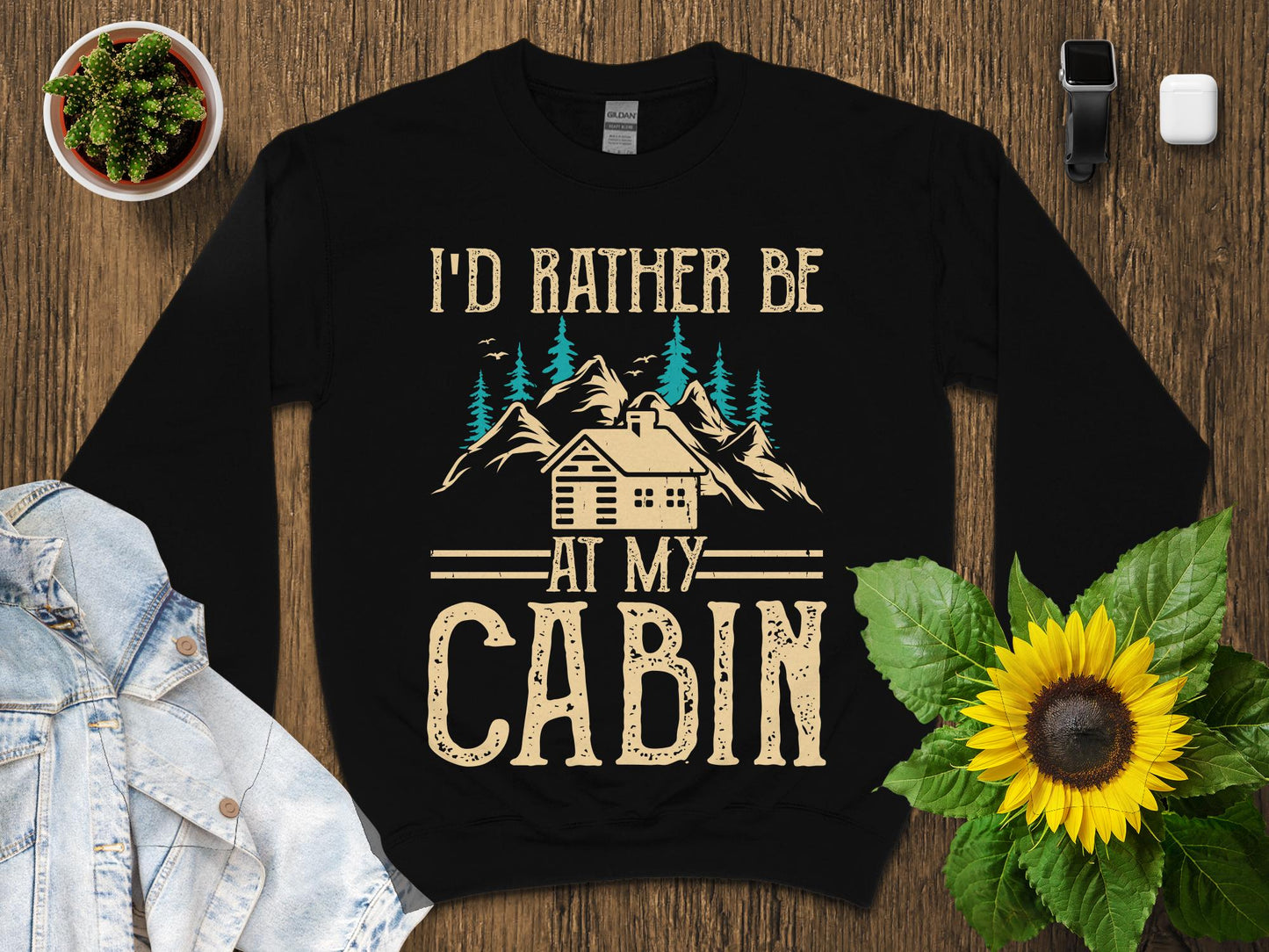 Black sweatshirt with "I'd rather be at my cabin" text and mountain graphic.