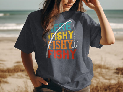 Woman wearing dark t-shirt with "Fishy Fishy Fishy" text and fishing rod graphic.