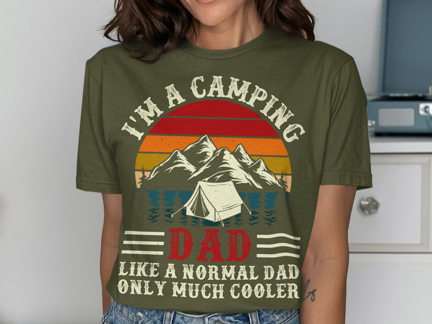 Olive green t-shirt with mountain and tent graphic and "I'm a camping dad" text.