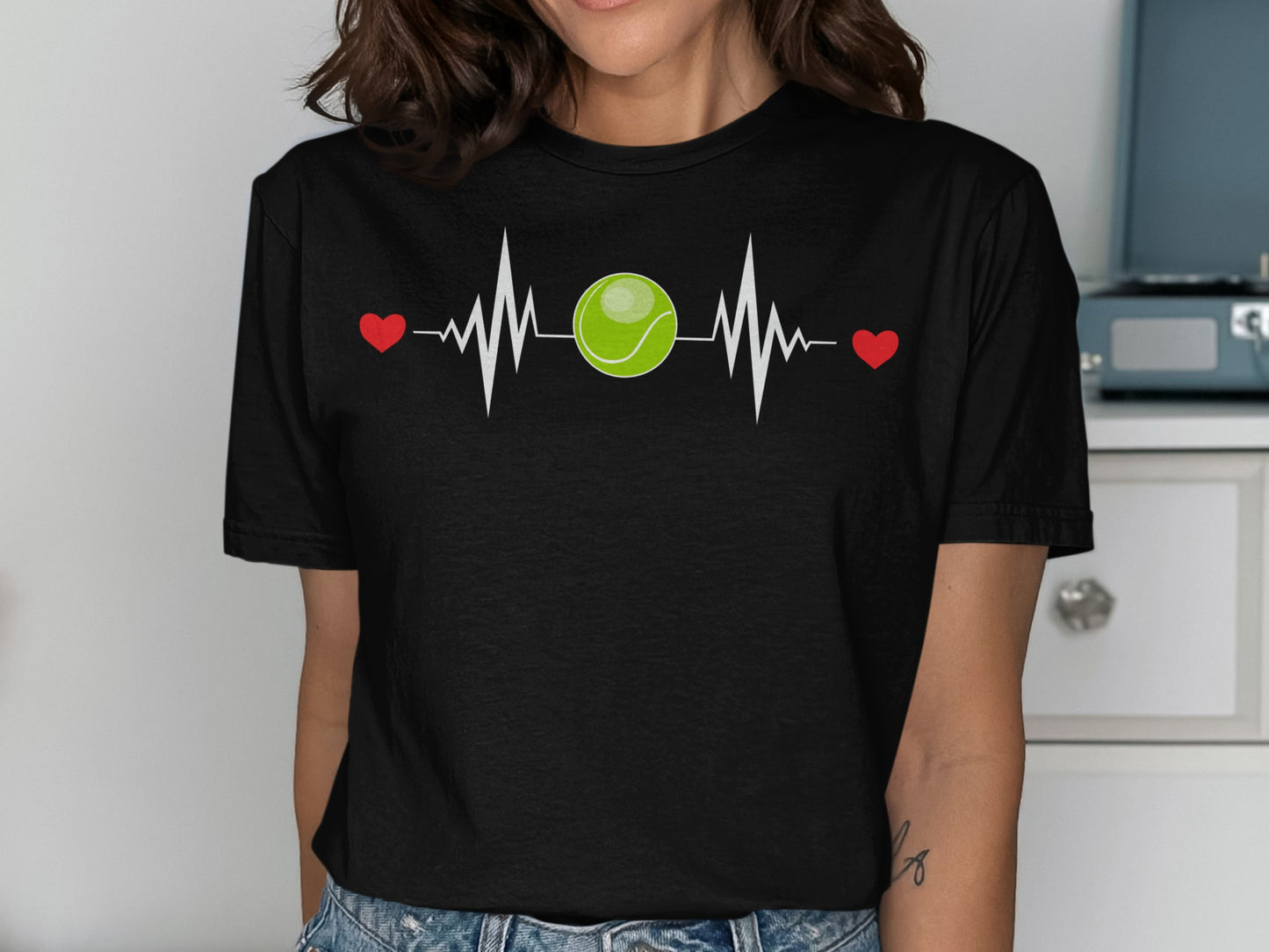 Black t-shirt with tennis ball and heartbeat graphic.