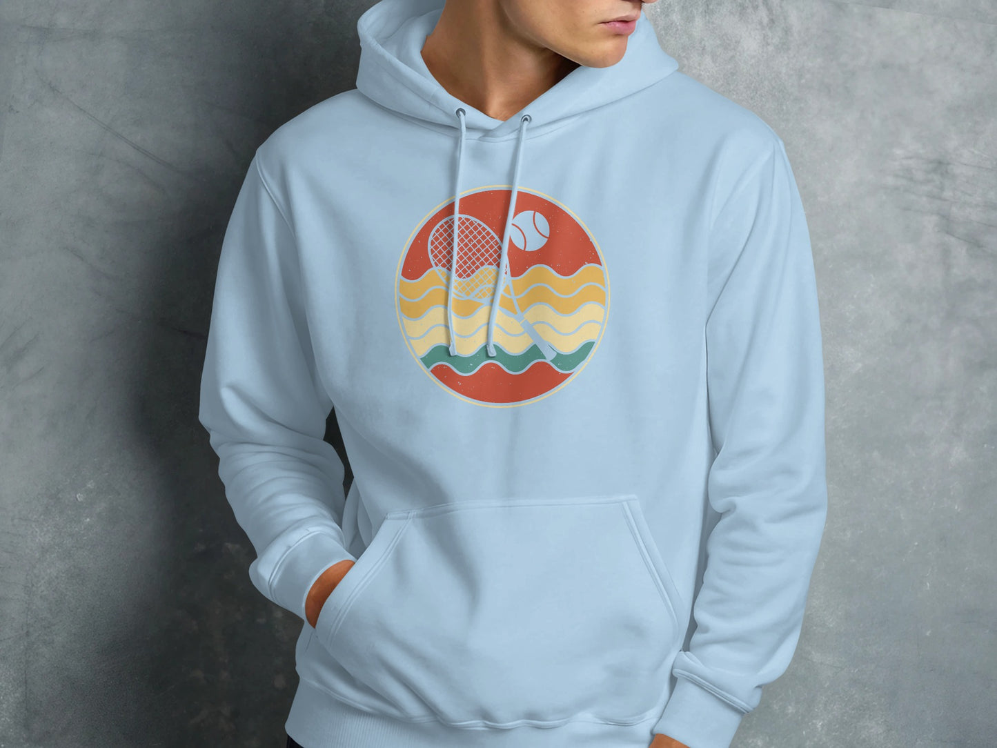 Light blue hoodie with circular tennis graphic featuring racket, ball, and wavy lines.