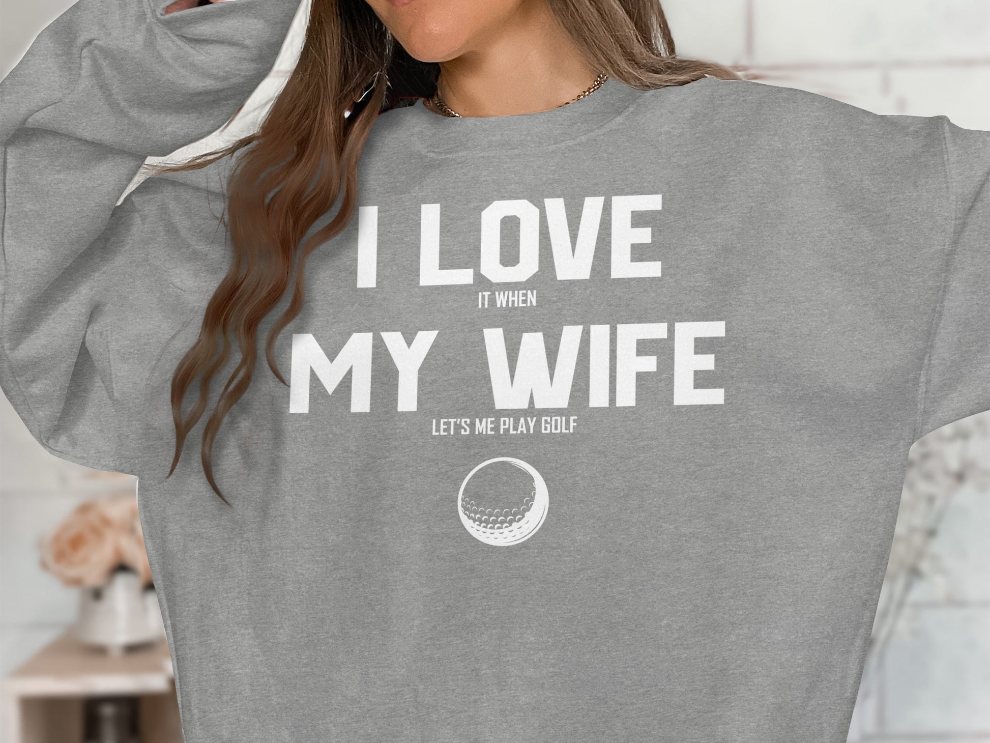 Grey sweatshirt with "I love my wife" and "Let's me play golf" text, and a golf ball graphic.