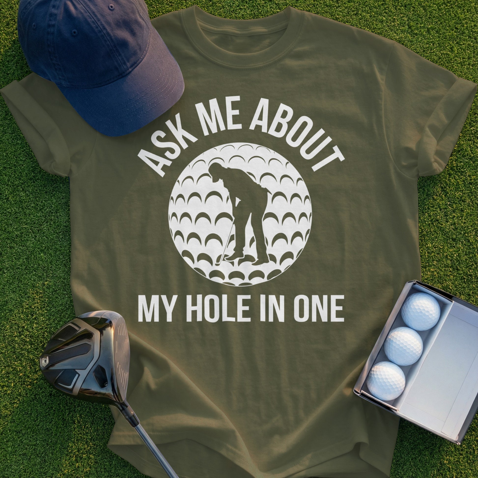 T-shirt with "Ask me about my hole in one" text and golfer graphic.