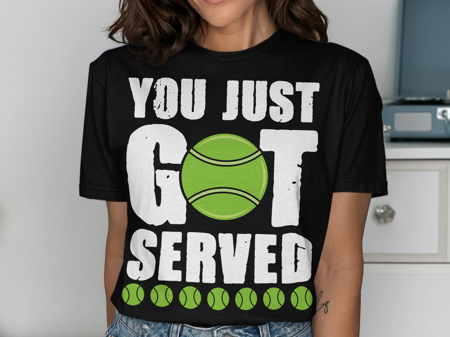 Black t-shirt with "YOU JUST GOT SERVED" and green tennis balls graphic.