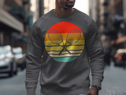 Gray sweatshirt with crossed tennis racquets in a colorful circle logo.