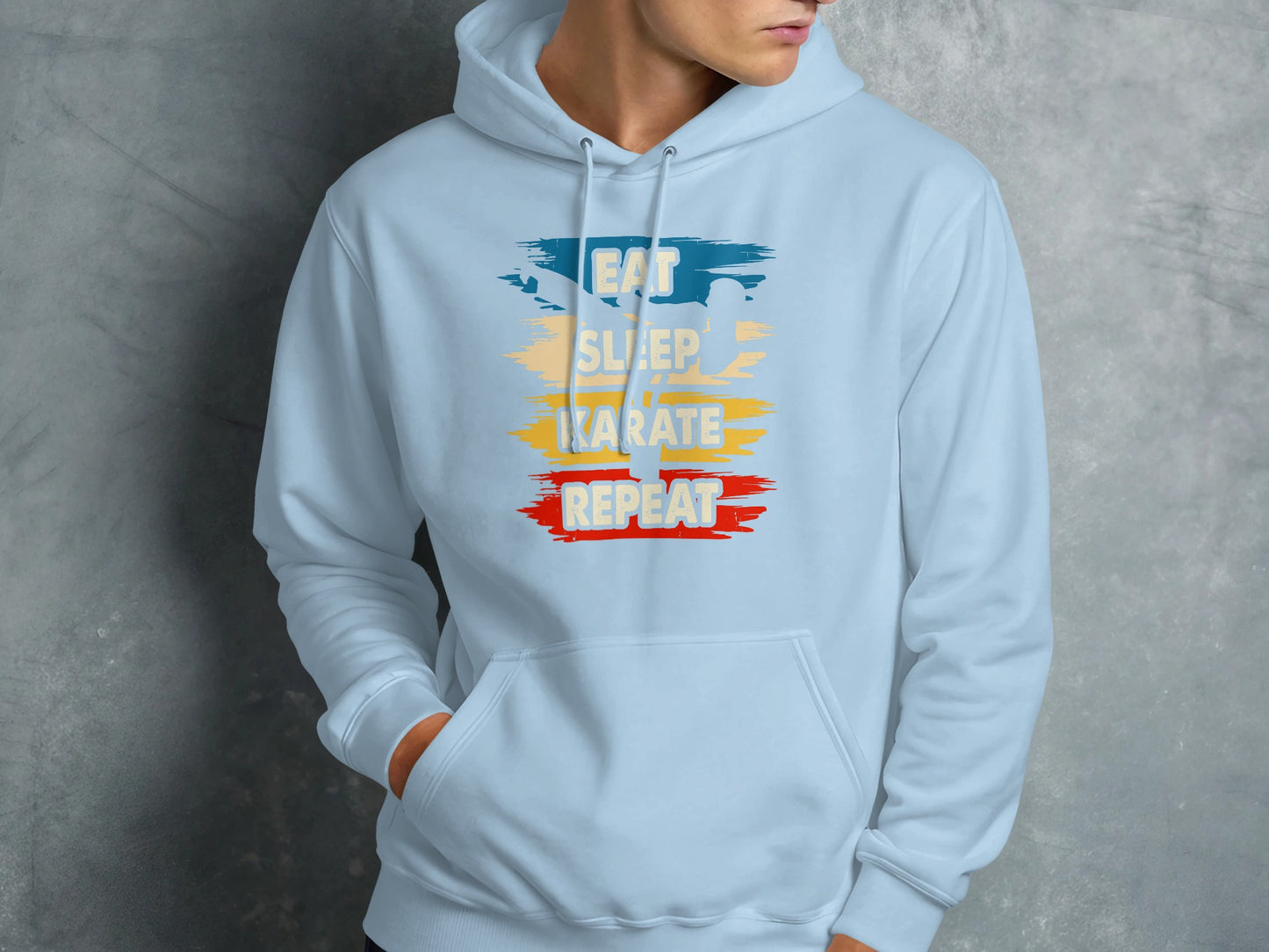 Light blue hoodie with "Eat Sleep Karate Repeat" text graphic.