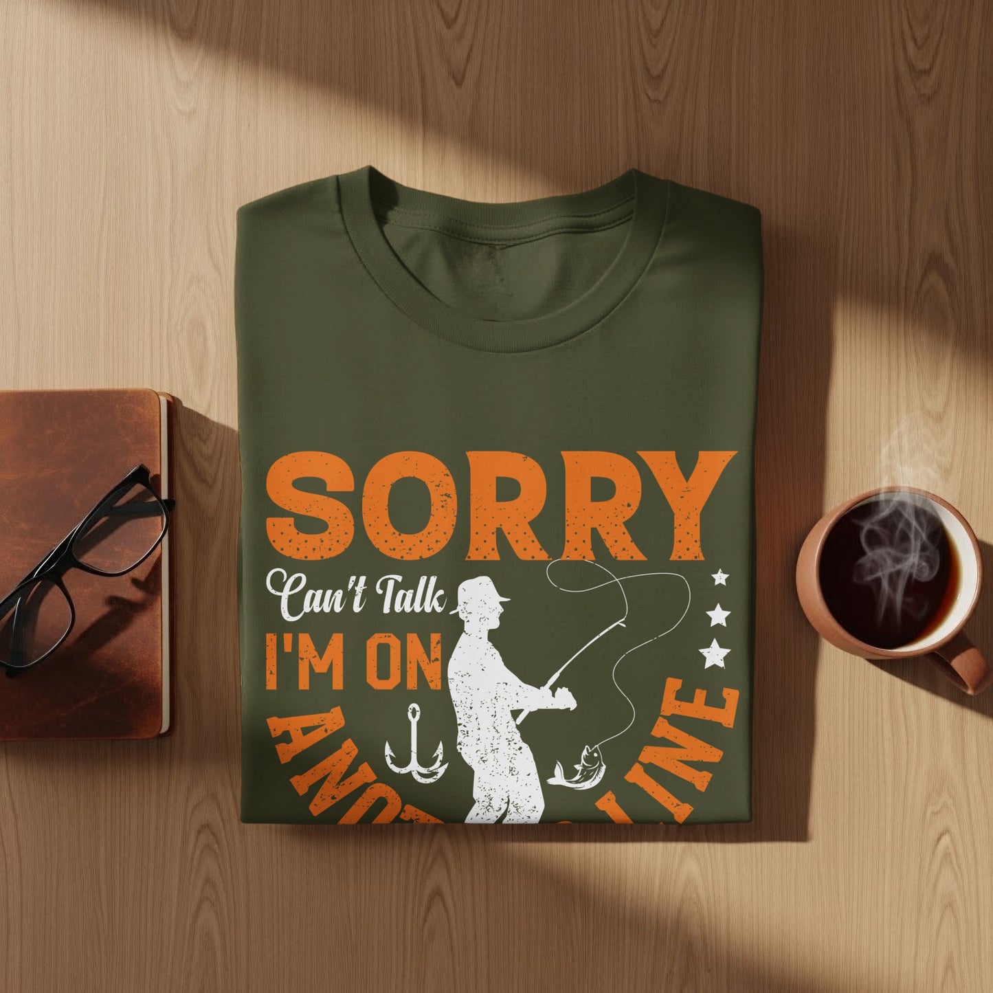 Olive green t-shirt with "Sorry Can't Talk I'm On The Line" fishing graphic.