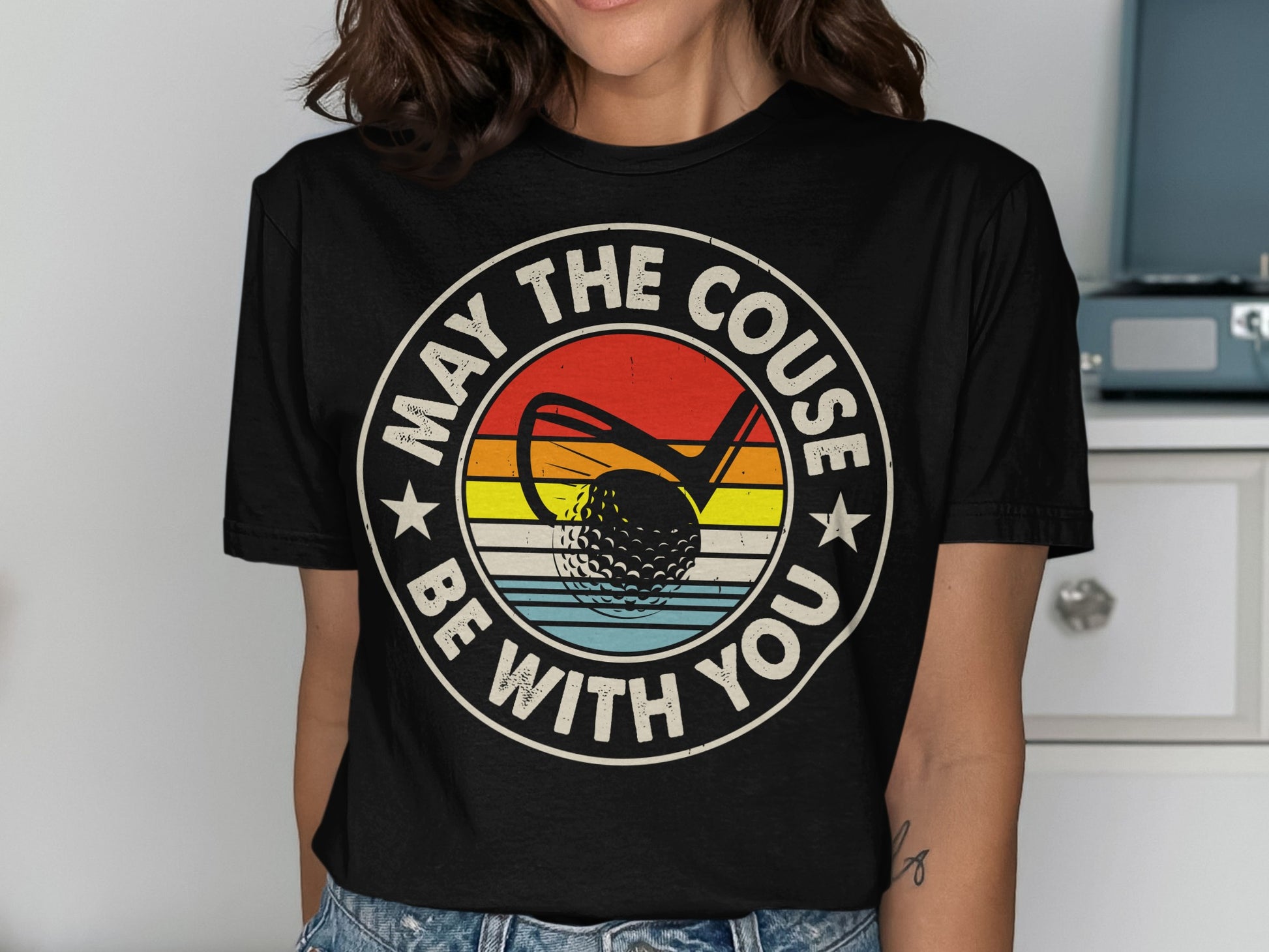 Golf shirt with "May the couse be with you" text and golf ball.