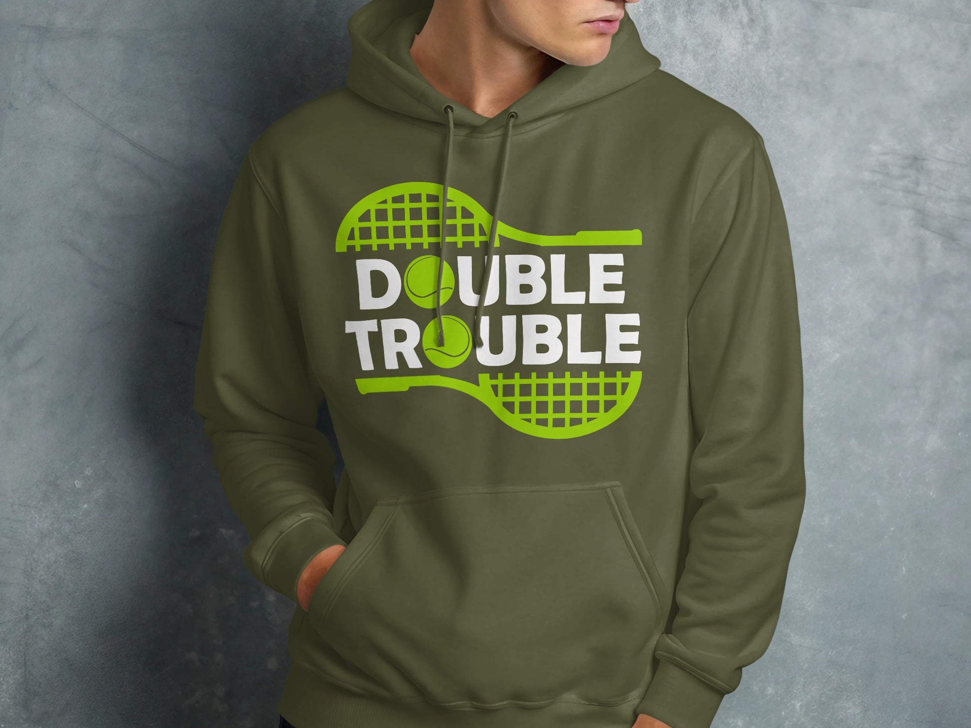 Green hoodie with "Double Trouble" text and tennis racket and ball graphic.
