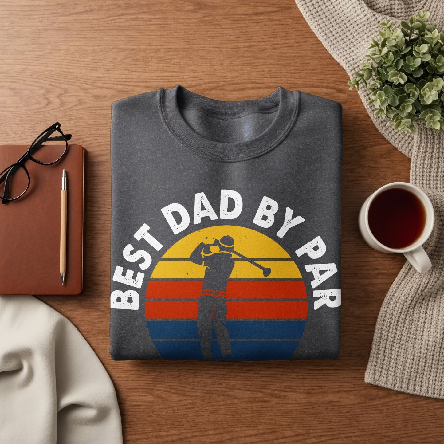 Dark grey t-shirt with "Best Dad by Par" text and a golfer at sunset graphic.