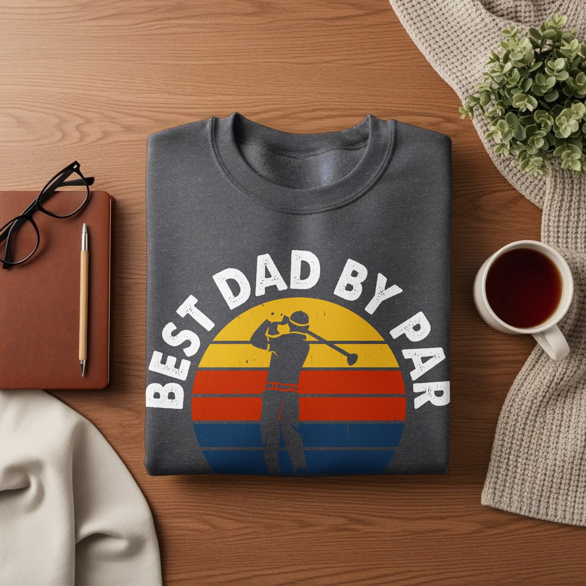 Dark grey t-shirt with "Best Dad by Par" text and a golfer at sunset graphic.