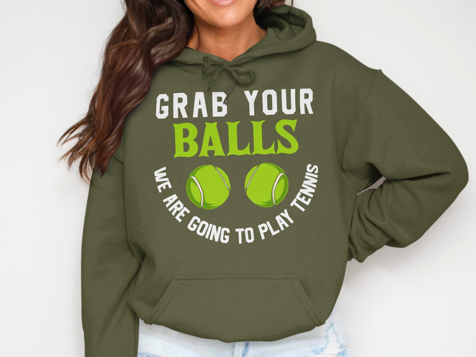Green hoodie with text "GRAB YOUR BALLS WE ARE GOING TO PLAY TENNIS" and two tennis balls.
