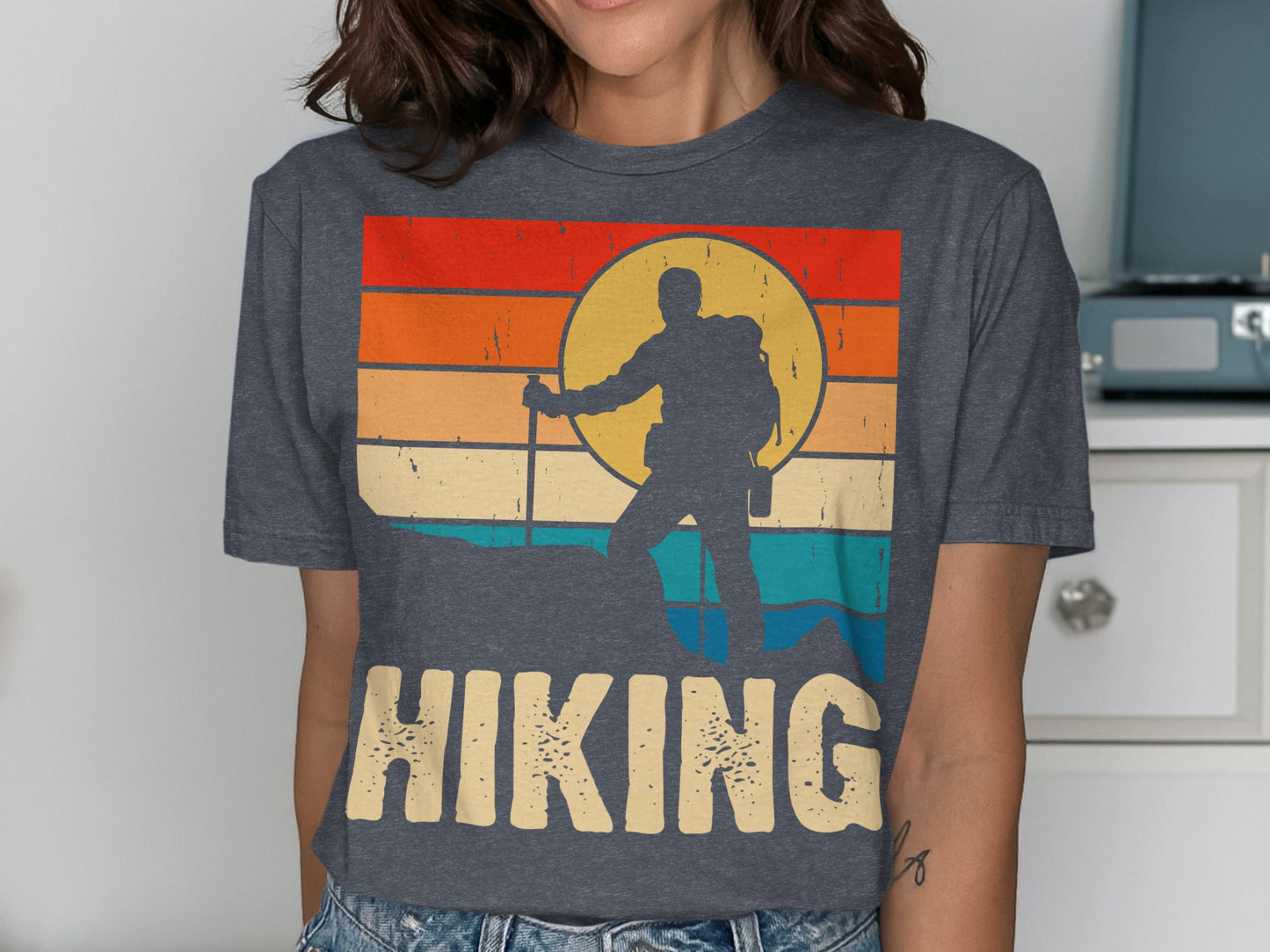 Silhouette of a hiker against a colorful sunset on a vintage t-shirt.