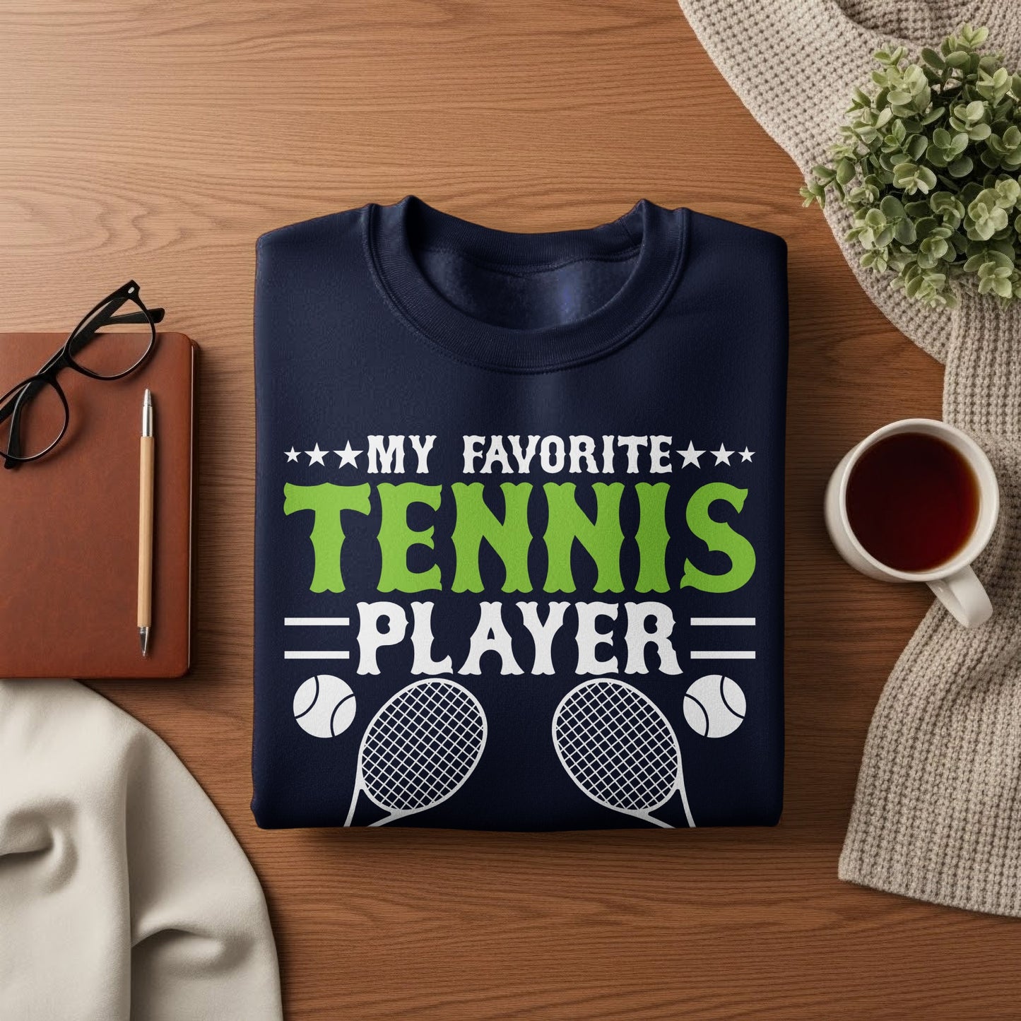 Navy sweatshirt with "My Favorite Tennis Player" text and tennis rackets.