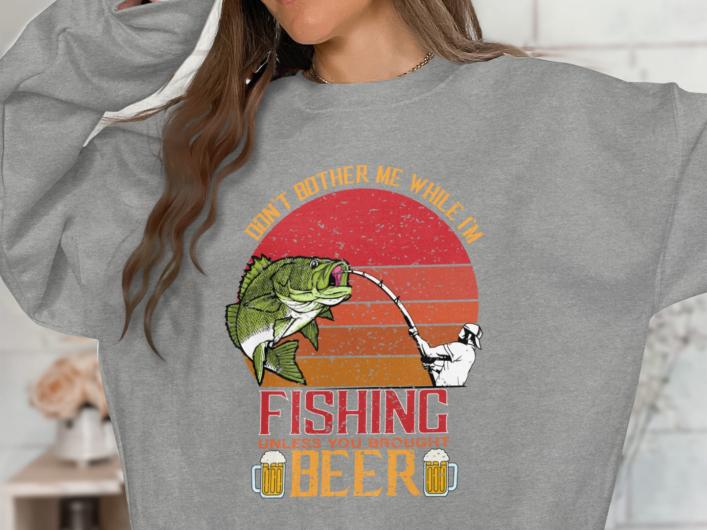 Gray sweatshirt with fishing graphic and beer mugs, reads "Don't Bother Me While I'm Fishing".