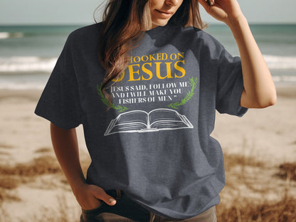 Dark t-shirt with "Hooked on Jesus" and Bible verse about fishers of men.