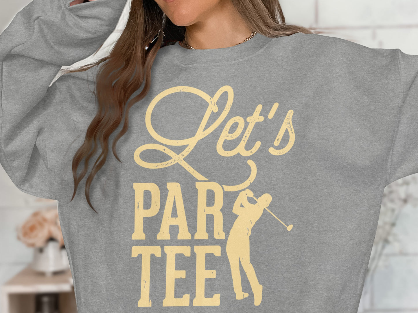 Grey sweatshirt with "Let's Par Tee" text and golfer graphic.