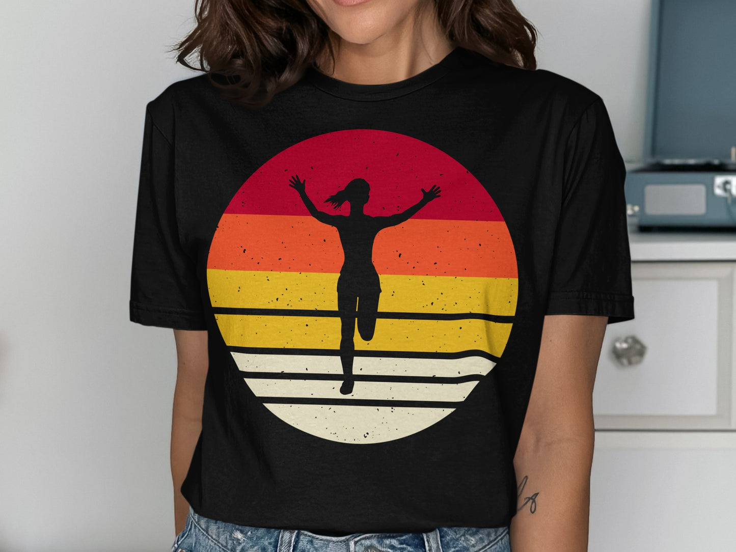 Runner silhouette arms raised against a colorful striped sunset circle.
