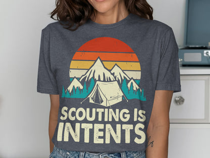 T-shirt with "Scouting is Intents" text, mountains, tent, and sunset graphic.