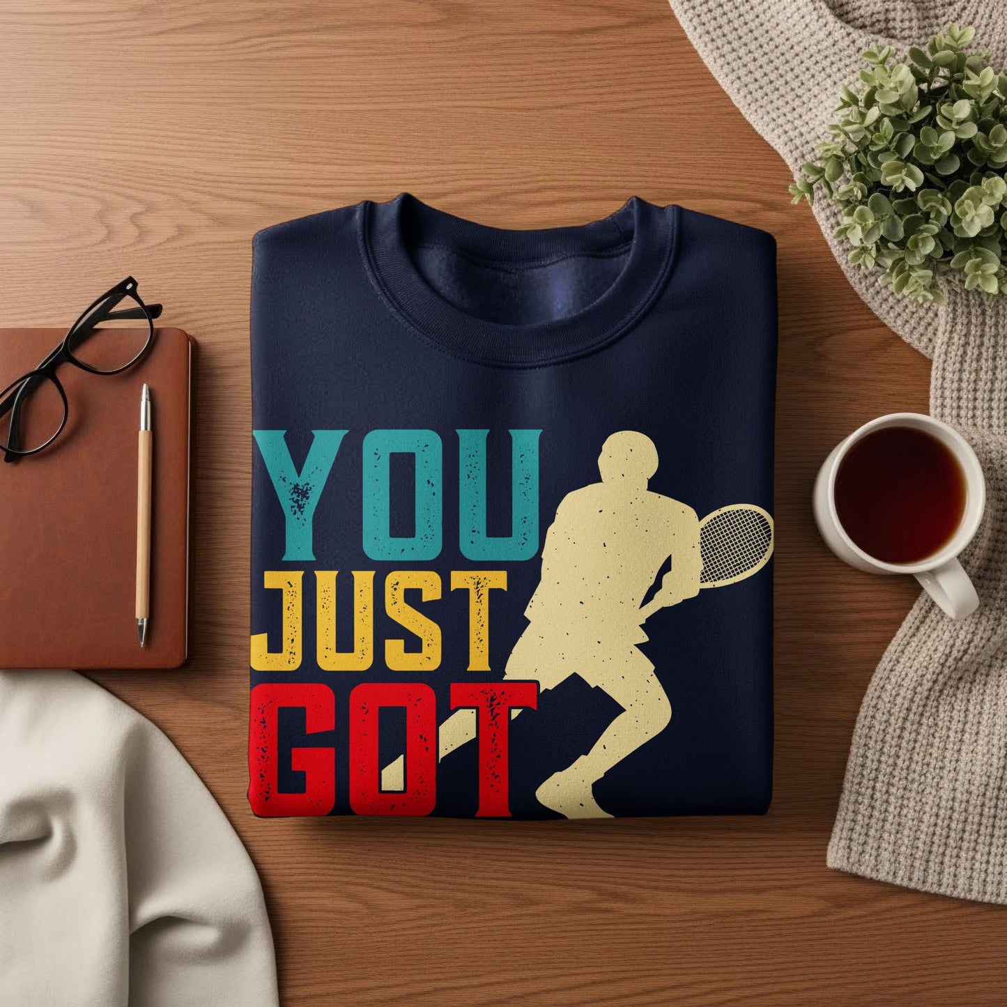 Navy sweatshirt with "YOU JUST GOT" text and tennis player graphic.