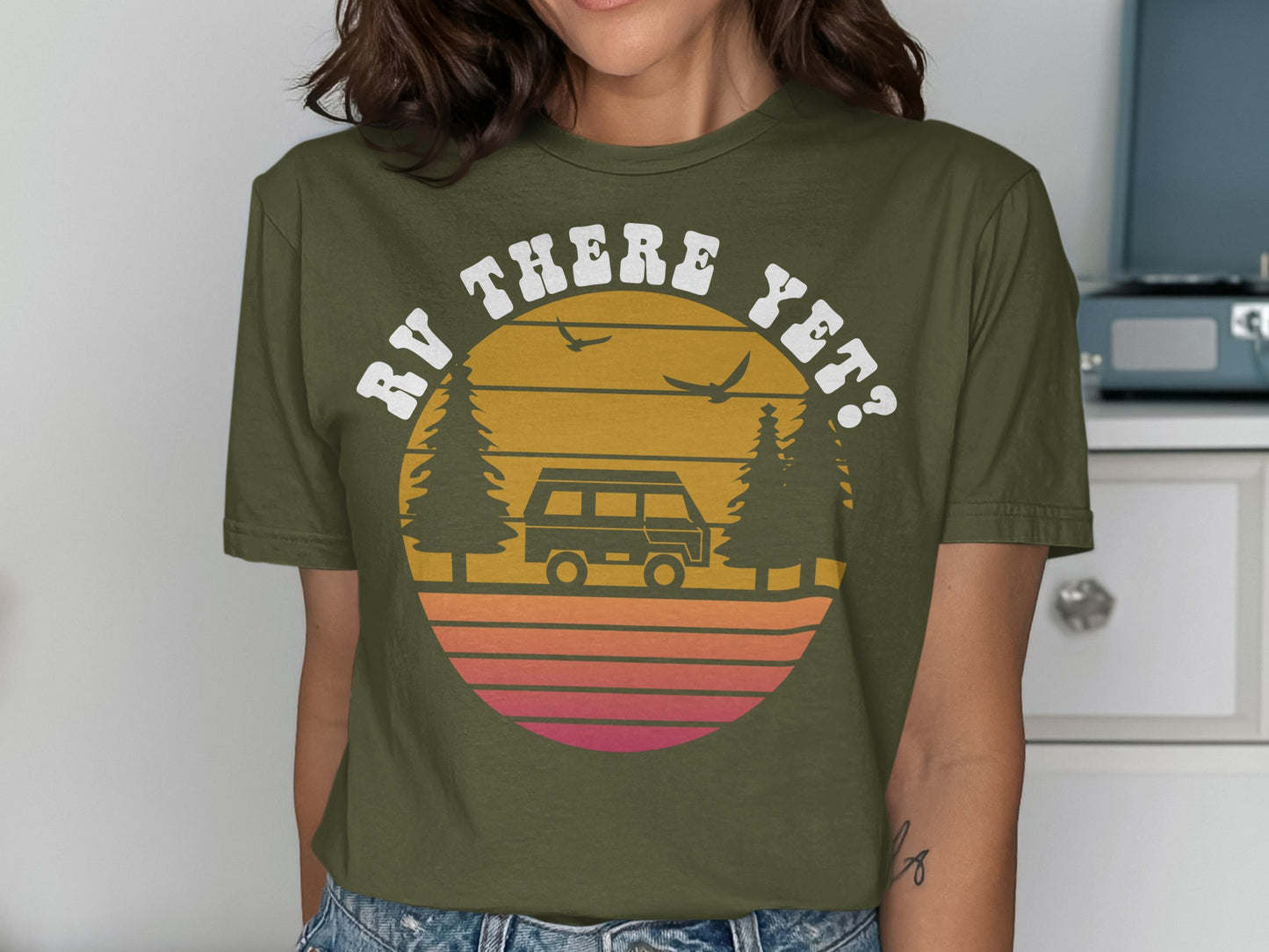 Green t-shirt with "RV THERE YET?" text over a sunset graphic.