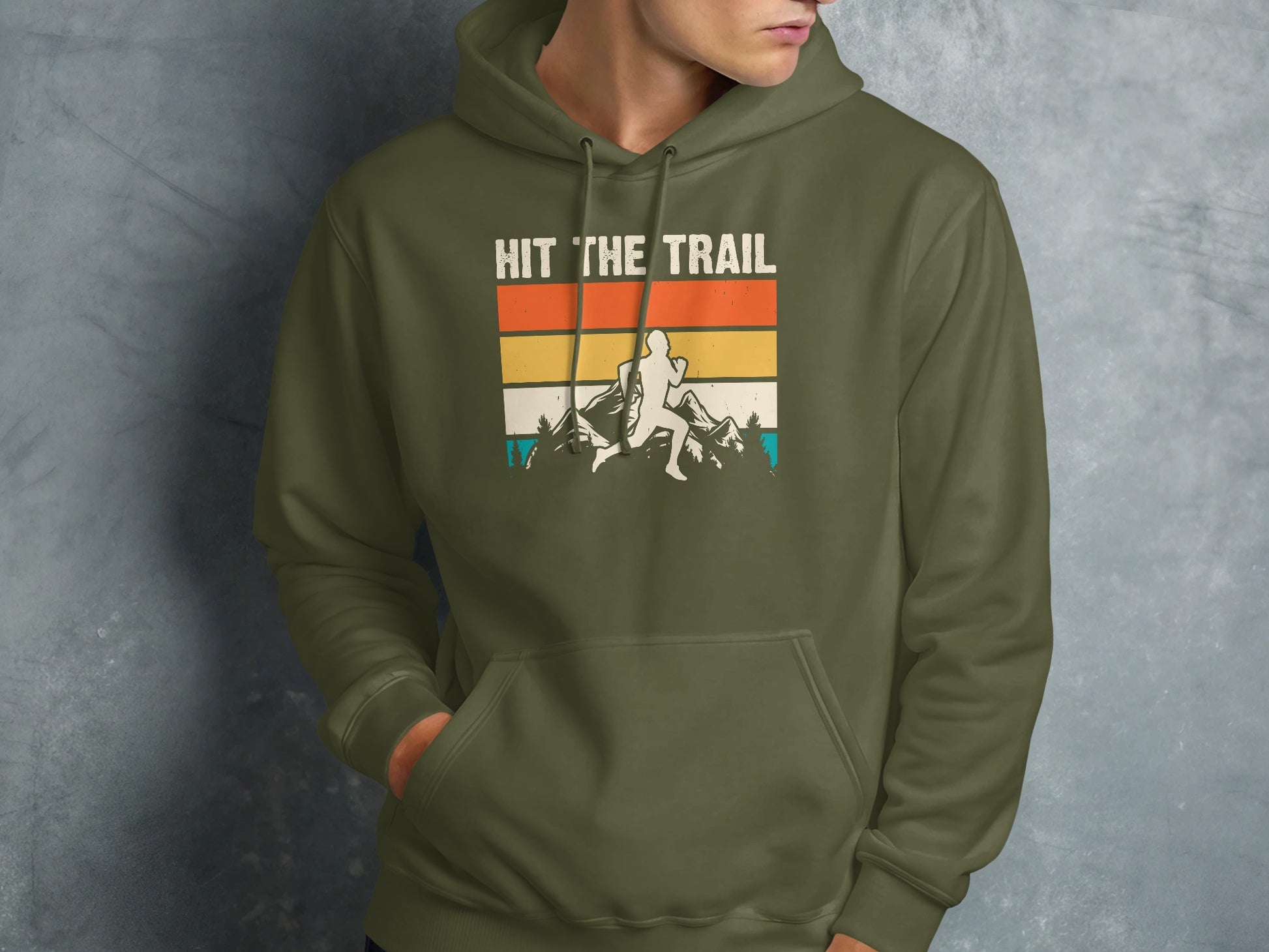 Green hoodie with "HIT THE TRAIL" text and mountain runner graphic.