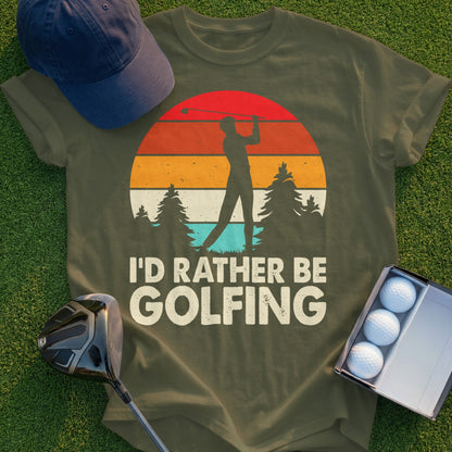 Olive green t-shirt with "I'd Rather Be Golfing" text and sunset graphic.