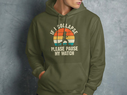 Olive green hoodie with vintage runner graphic and text "IF I COLLAPSE PLEASE PAUSE MY WATCH".