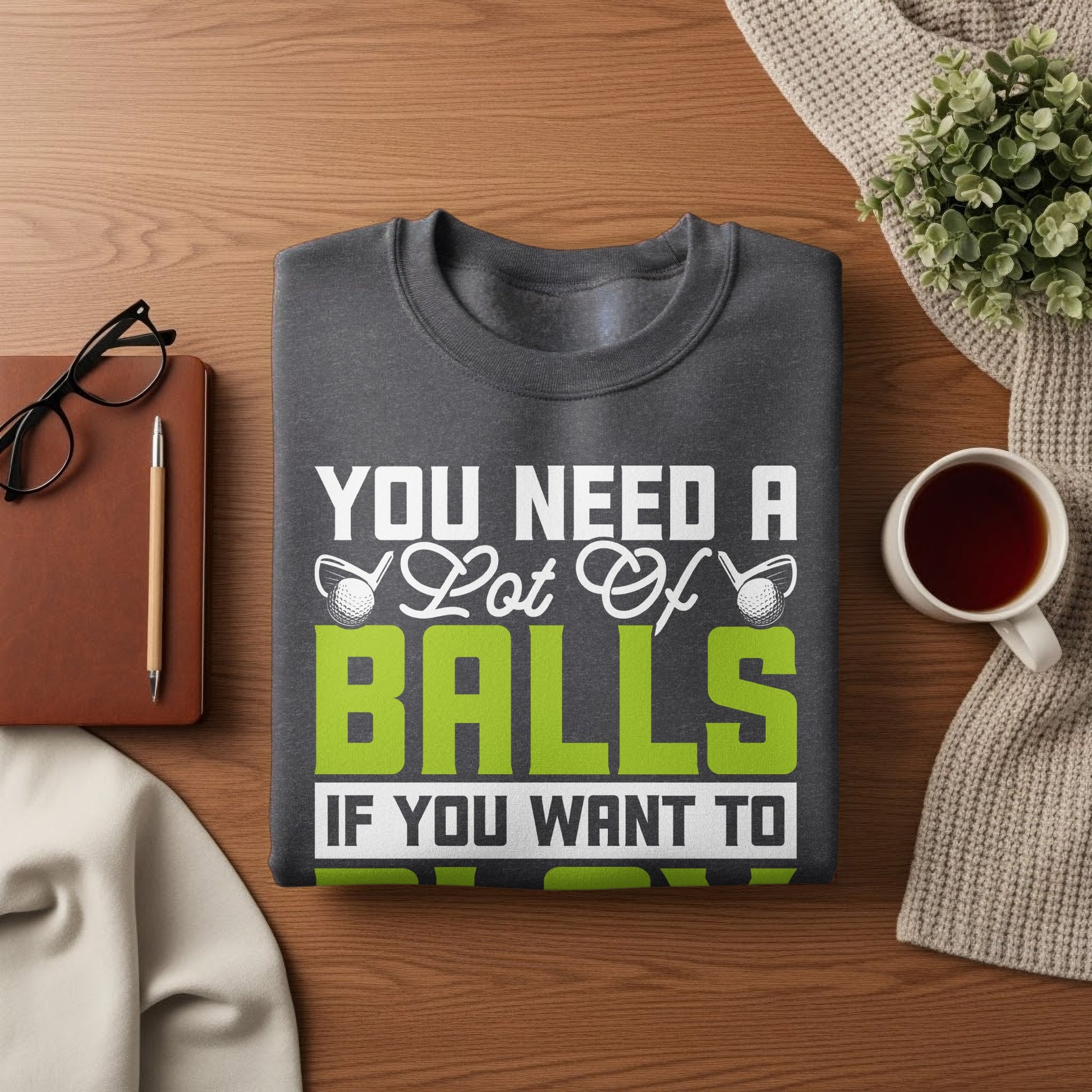 Dark gray sweatshirt with "You Need A Lot Of BALLS If You Want To" text and golf ball graphics.