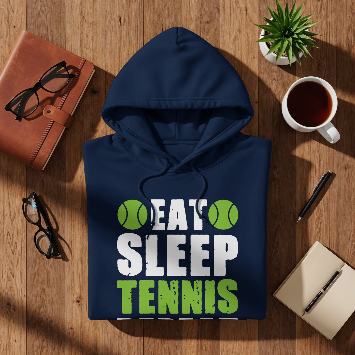 Navy hoodie with "EAT SLEEP TENNIS" text and tennis balls graphic.