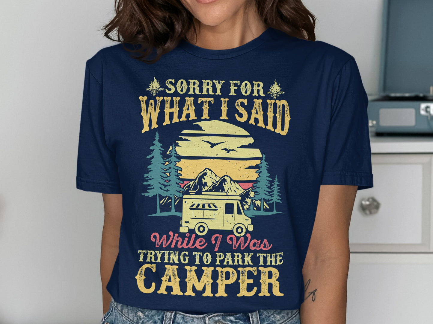 Navy t-shirt with camper, mountains, trees, and text "Sorry for what I said while trying to park the camper".