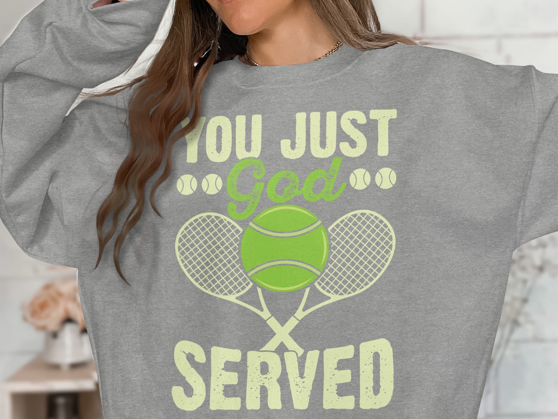 Gray sweatshirt with "YOU JUST God SERVED" and tennis graphics.