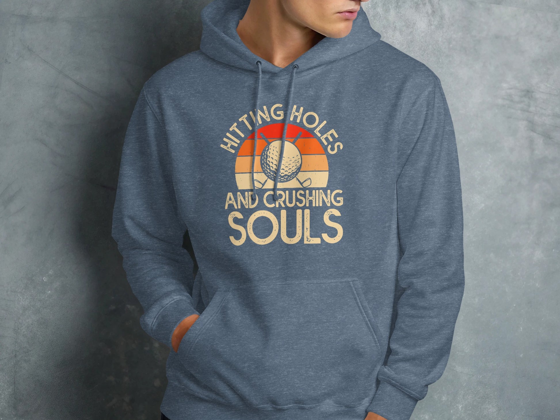 Blue hoodie with "Hitting Holes and Crushing Souls" text and golf ball.
