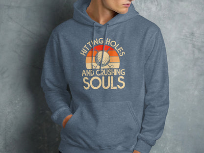 Blue hoodie with "Hitting Holes and Crushing Souls" text and golf ball.