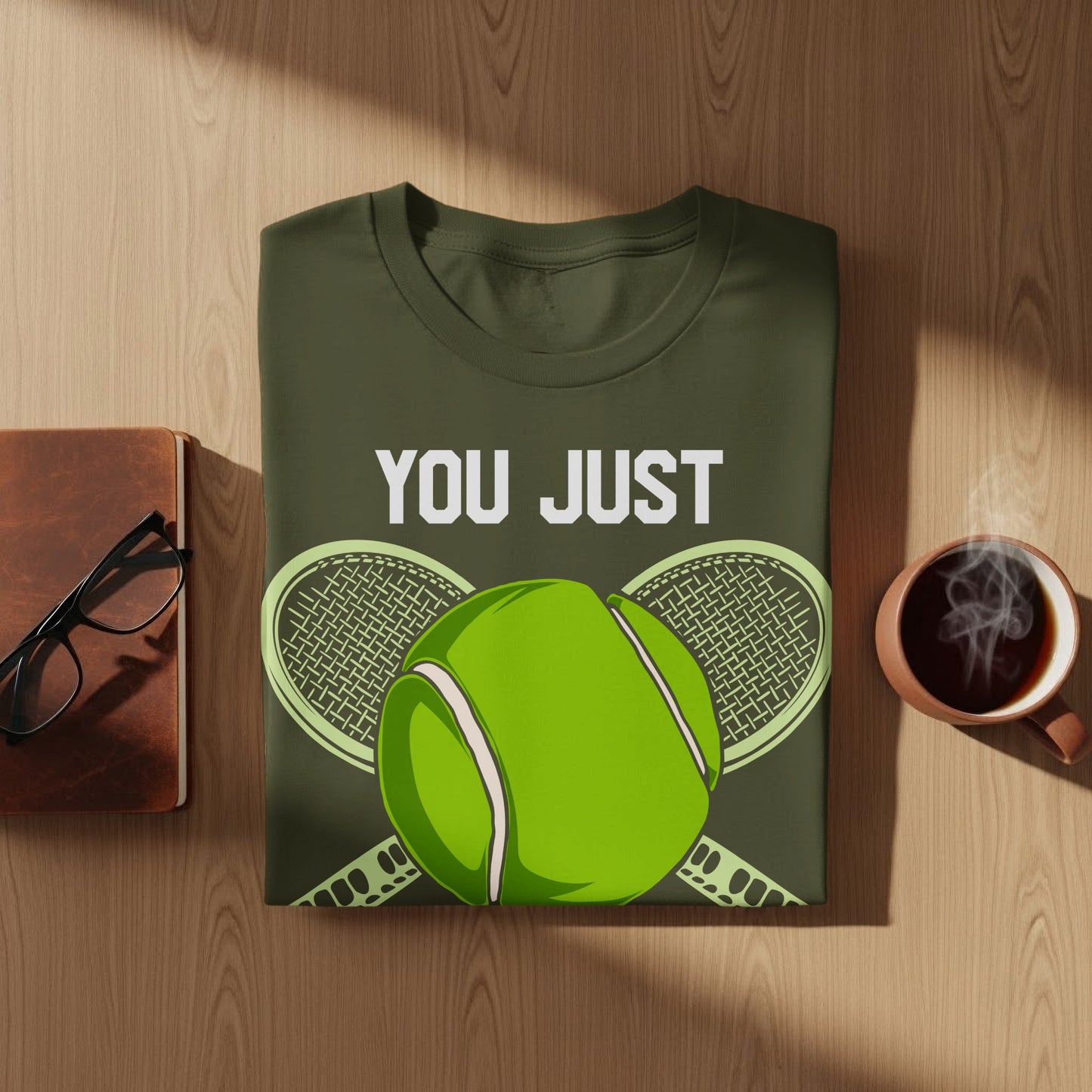 Green t-shirt with "YOU JUST" text and tennis racket and ball graphic.
