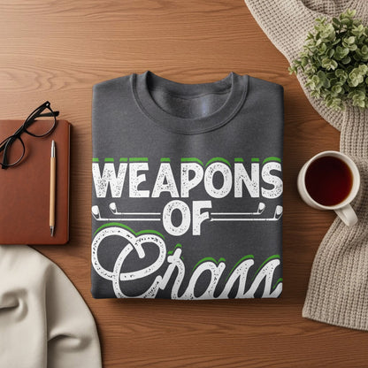 Dark grey sweatshirt with "Weapons of Grass" text and golf imagery.