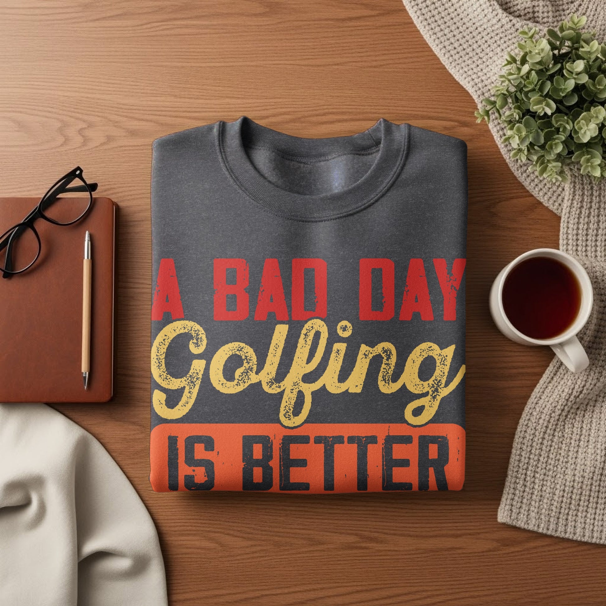 Dark gray sweatshirt with "A Bad Day Golfing Is Better" text.