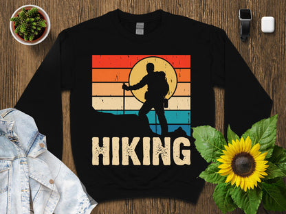 Silhouette hiker on a mountain peak with "Hiking" text.