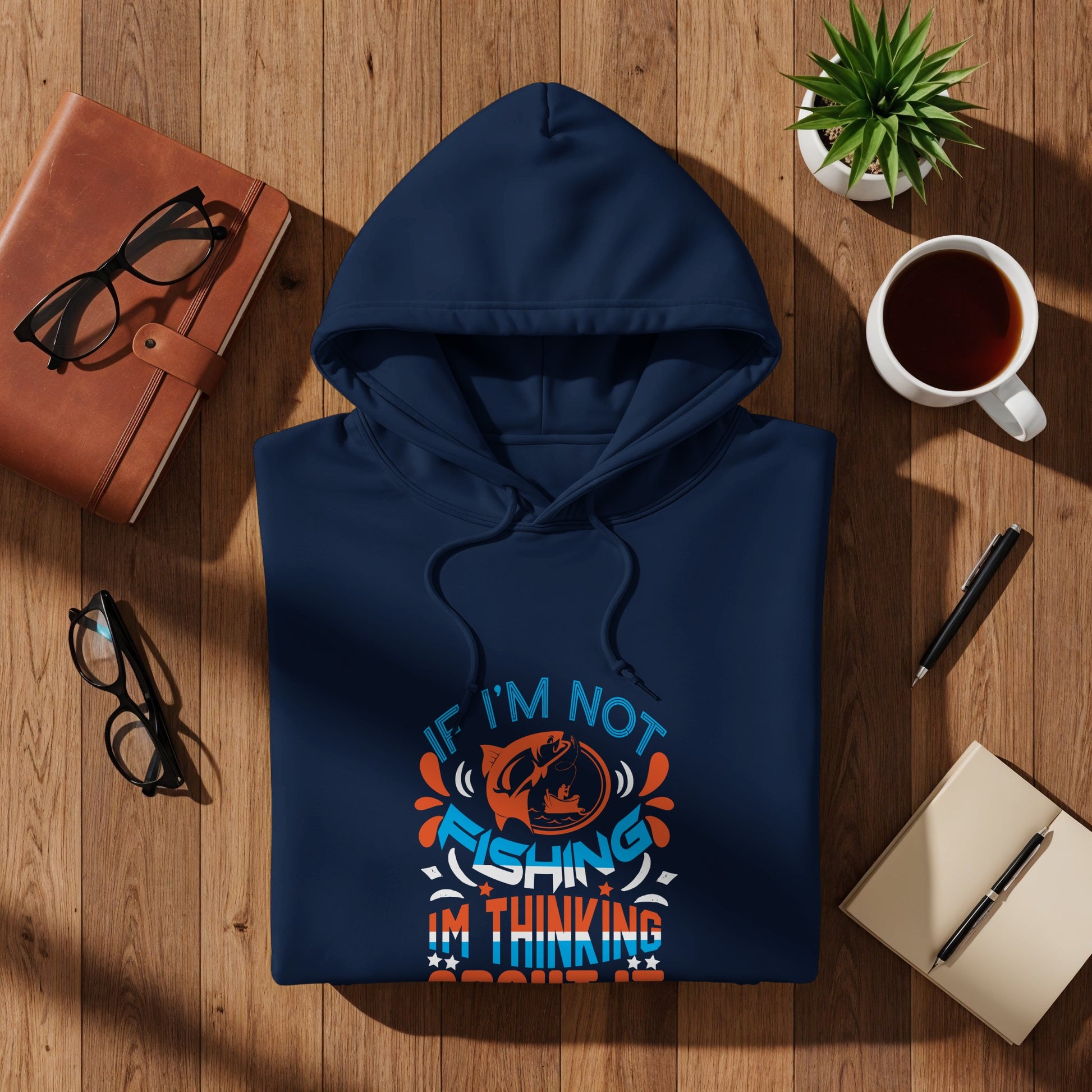 Navy blue hoodie with "If I'm not fishing I'm thinking about fishing" text and graphic.