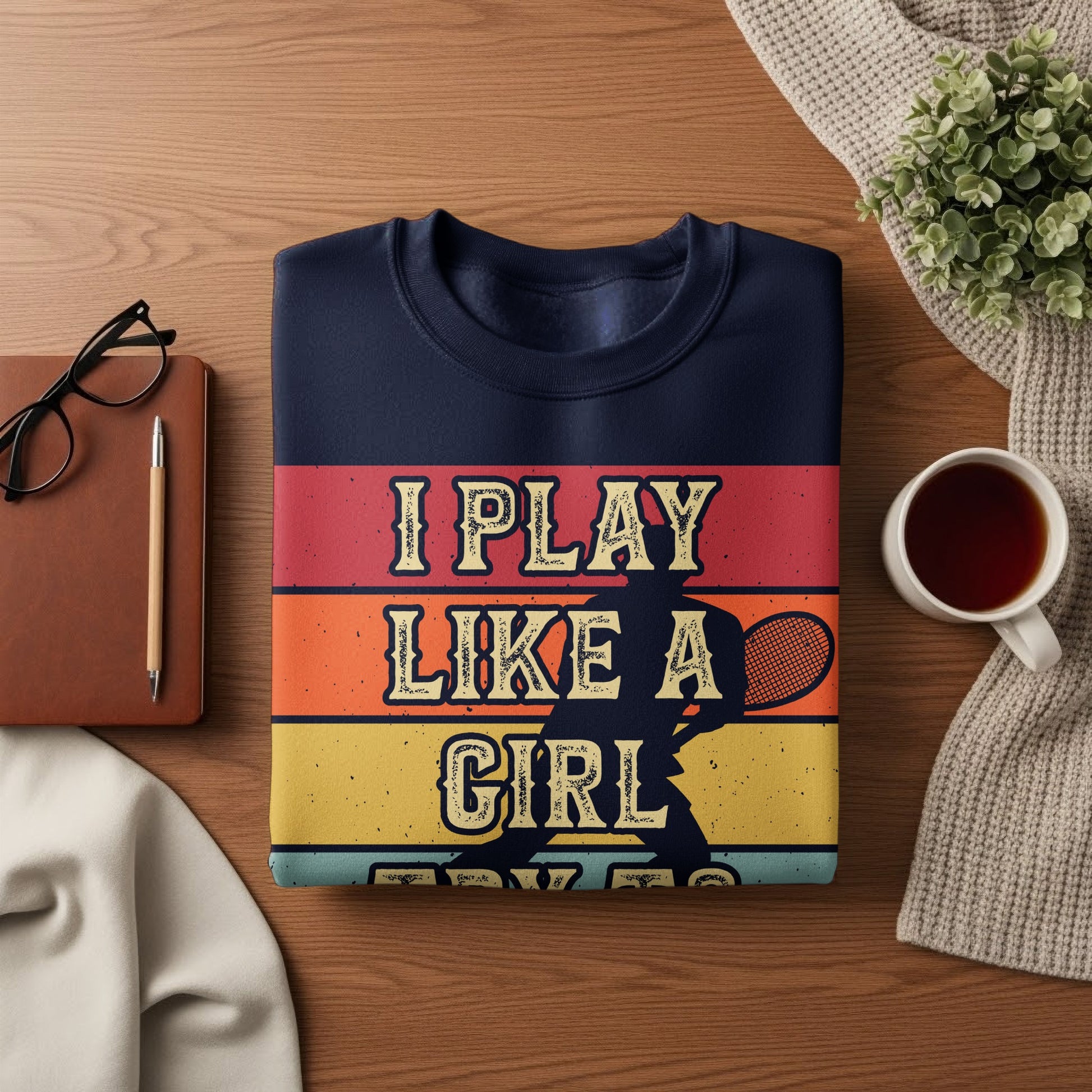 Navy sweatshirt with "I play like a girl" in colorful striped text.