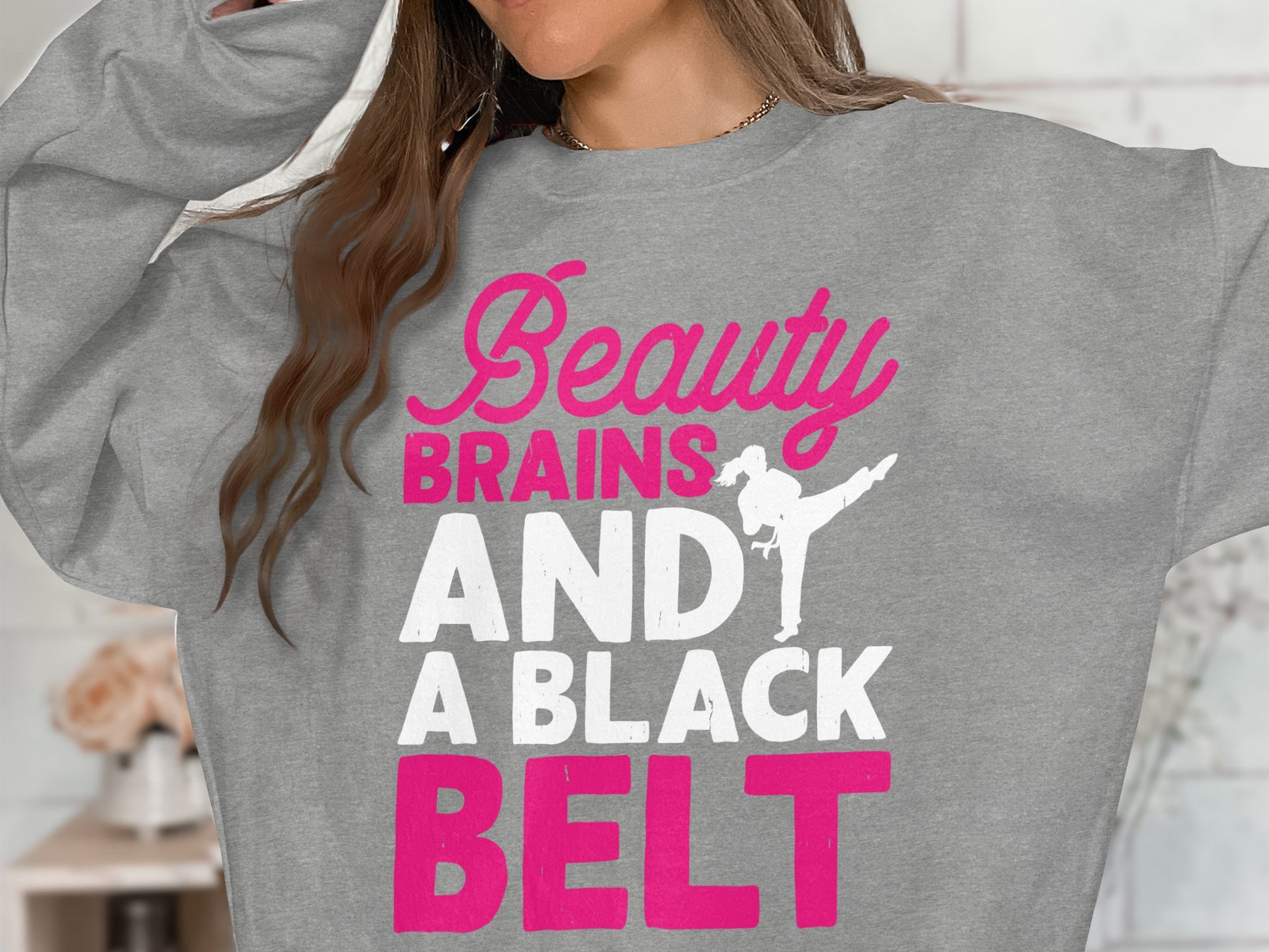 Gray sweatshirt with "Beauty Brains AND A BLACK BELT" in pink text.