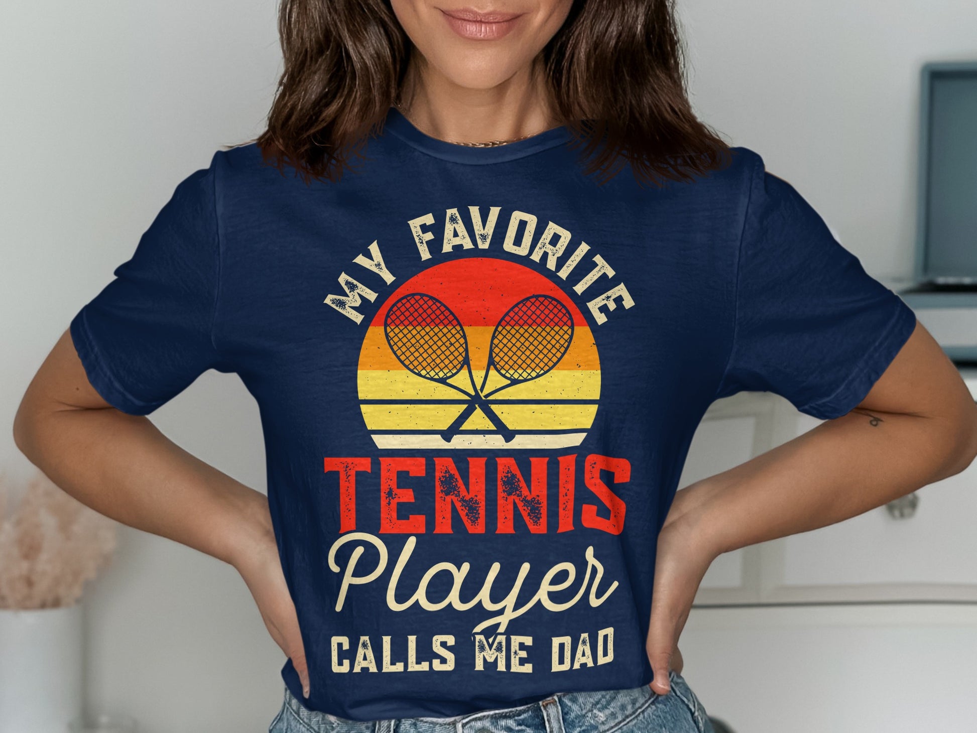 Navy t-shirt with "My Favorite Player Calls Me Dad" and crossed tennis rackets graphic.