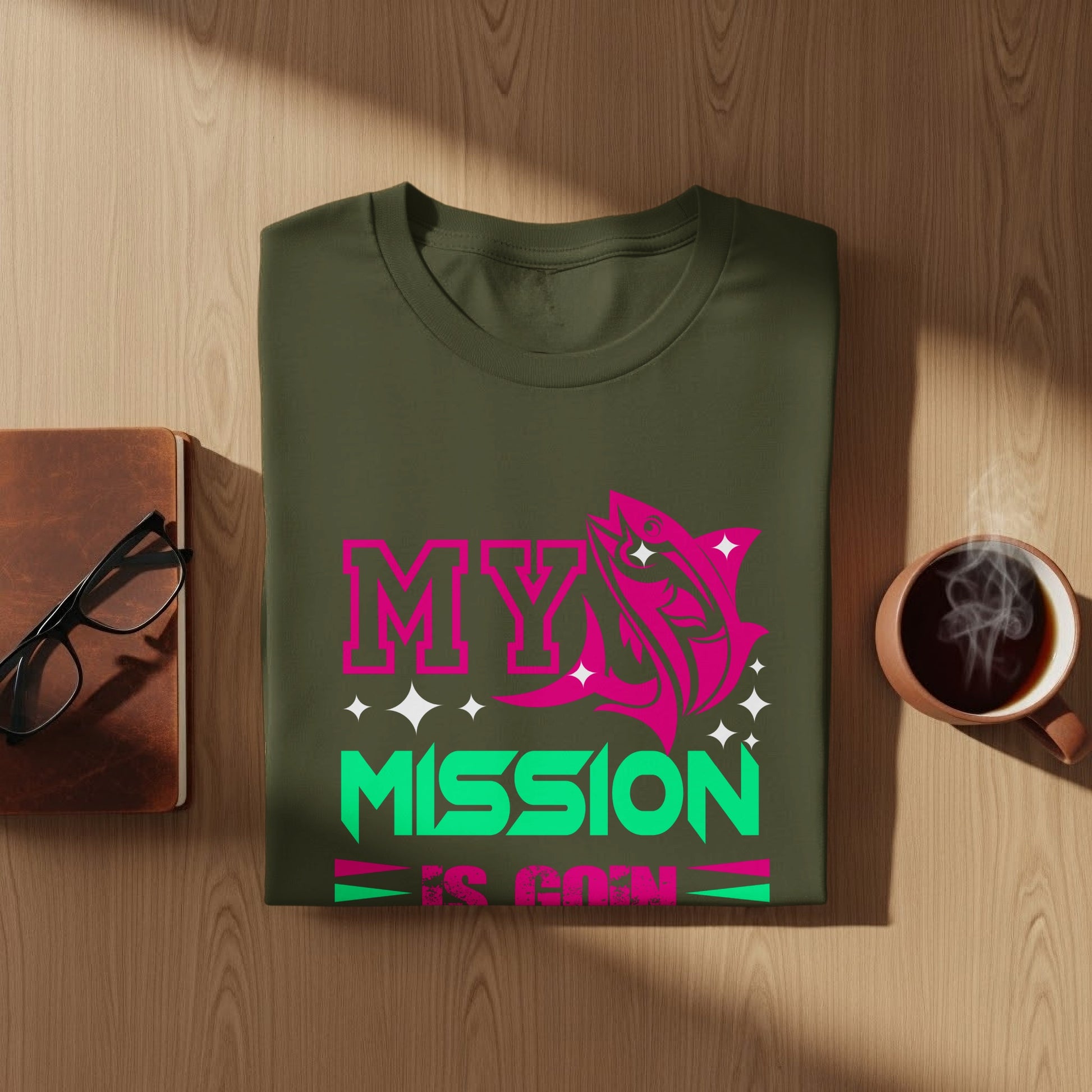 Olive green t-shirt with "MY MISSION IS COIN" text and a fish graphic.
