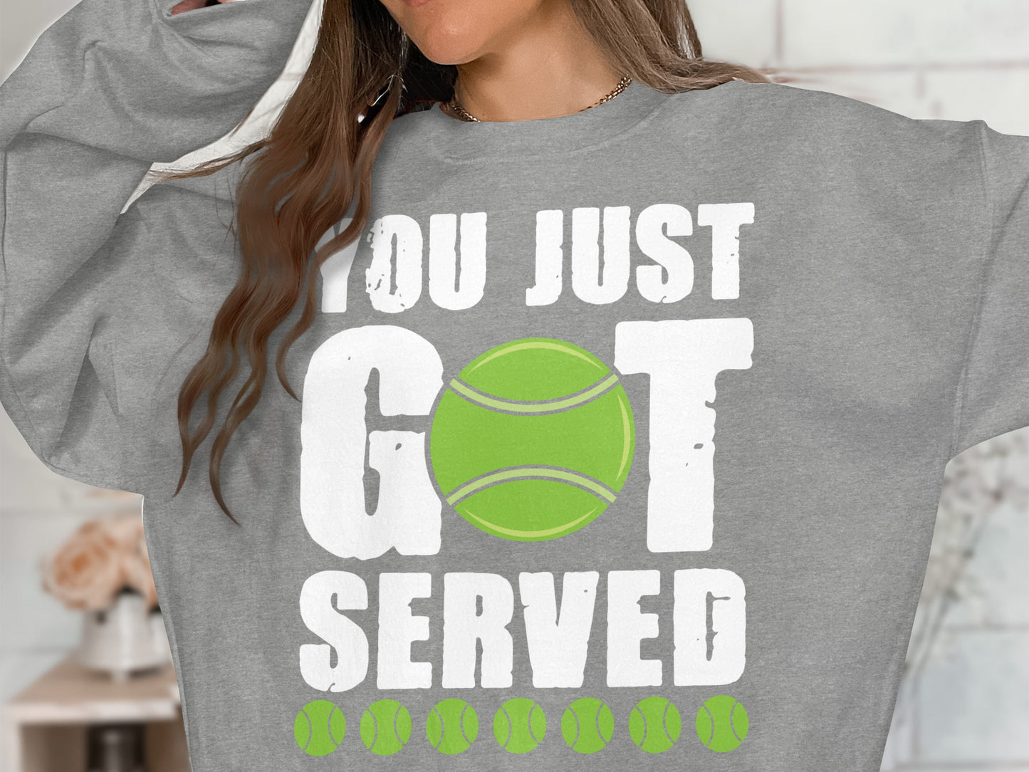 Gray sweatshirt with "YOU JUST GOT SERVED" and tennis ball graphics.