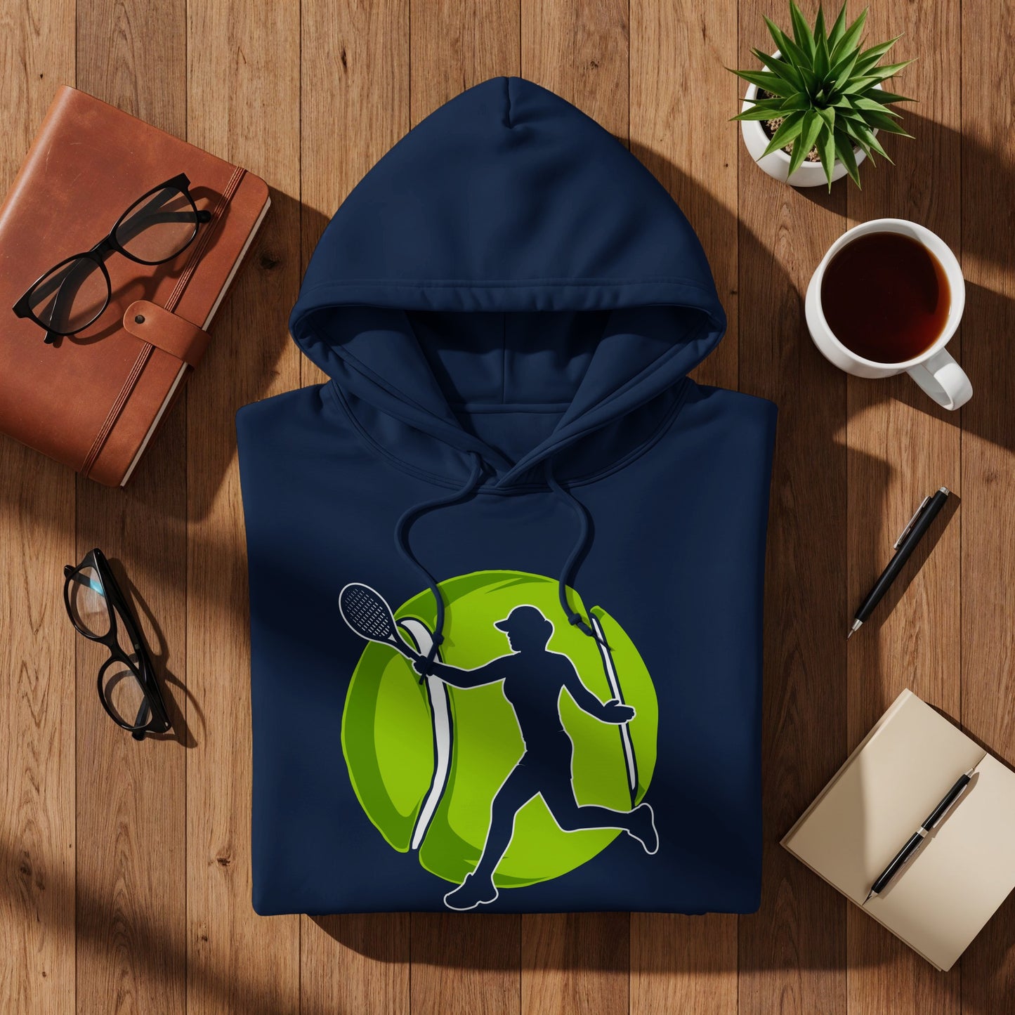 Navy blue hoodie with a lime green tennis ball and player graphic.